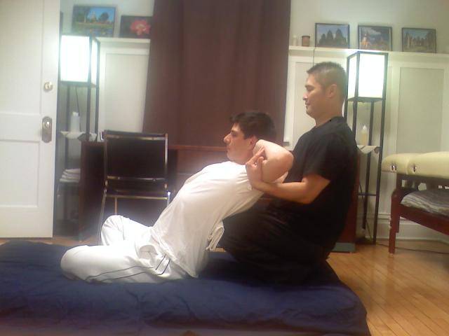 Thai_massage_sitting_back_stretch.jpg